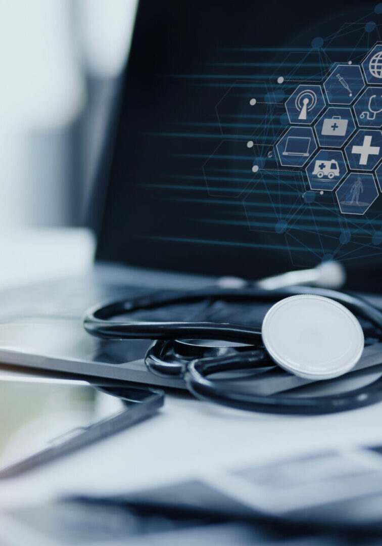 Doctor stethoscope with laptop on desk. A stethoscope rests on an open laptop displaying healthcare icons, with a tablet nearby on a desk.